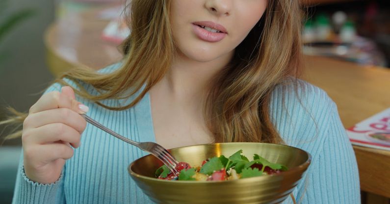 Waldorf Salad - A woman holding a bowl of salad in front of her