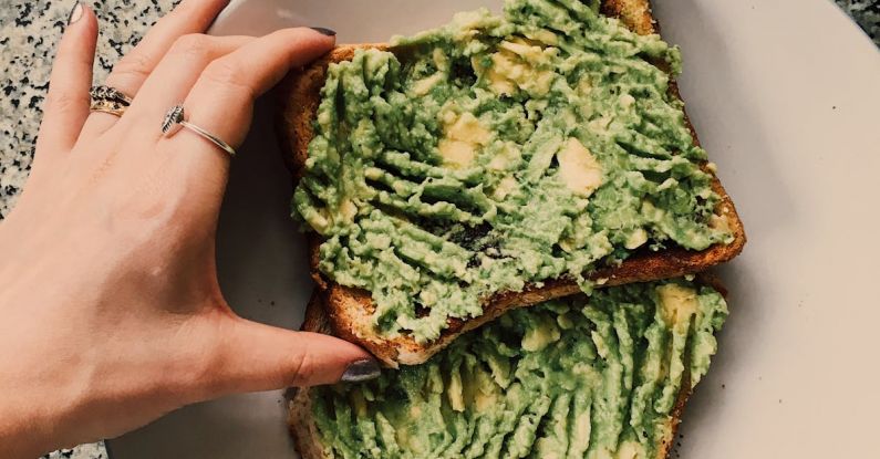 Guacamole - Person Holding Sandwich