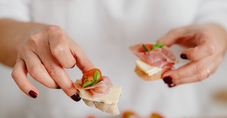 Canapés - Hands of a Woman Holding Canapes