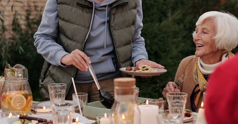 Thanksgiving - A Woman in Gray Jacket Getting Food on the Table