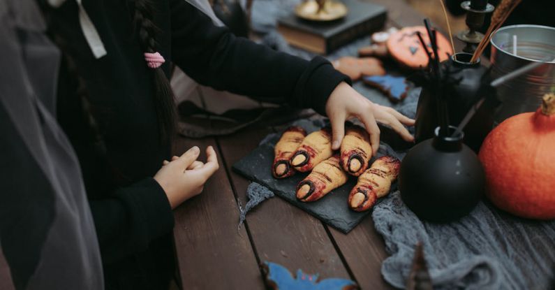 Halloween Treats - A Child Getting a Halloween Treat Shaped as Fingers