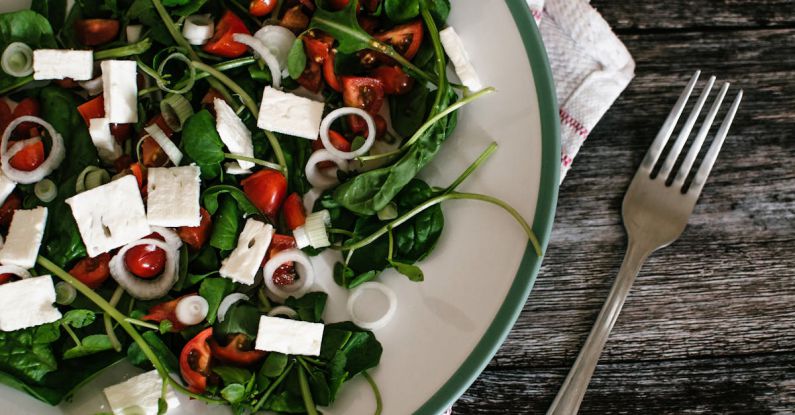 Greek Salad - Vegetable Salad on White Ceramic Plate Beside Grey Stainless Steel Fork